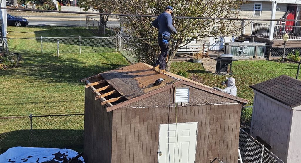 Tearing off old shed roof in New Castle, DE