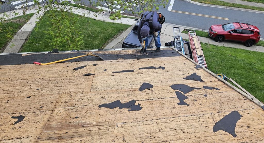 Tearing off old roof in New Castle, DE