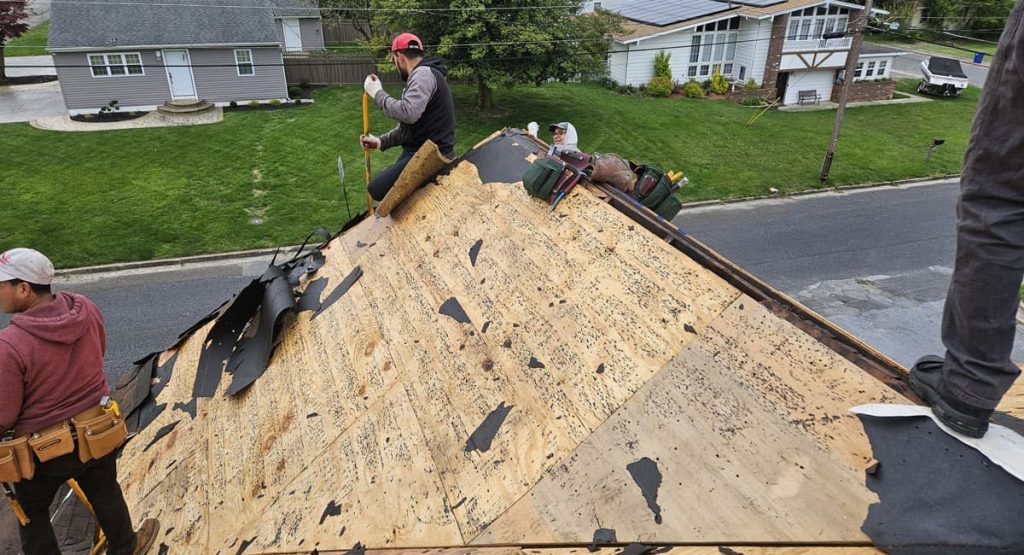 Tearing off old roof in Pennsville, NJ