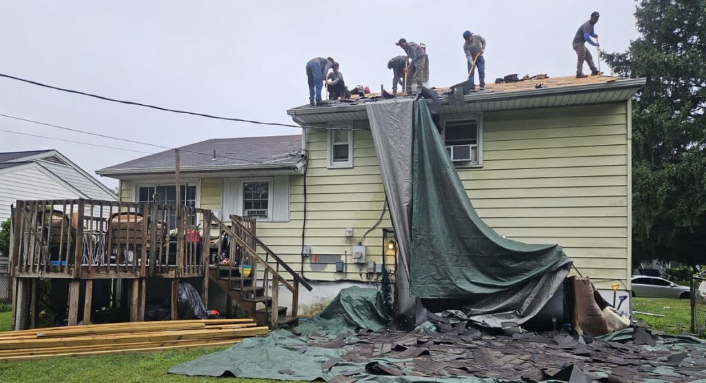 Tearing off old roof in New Castle, DE