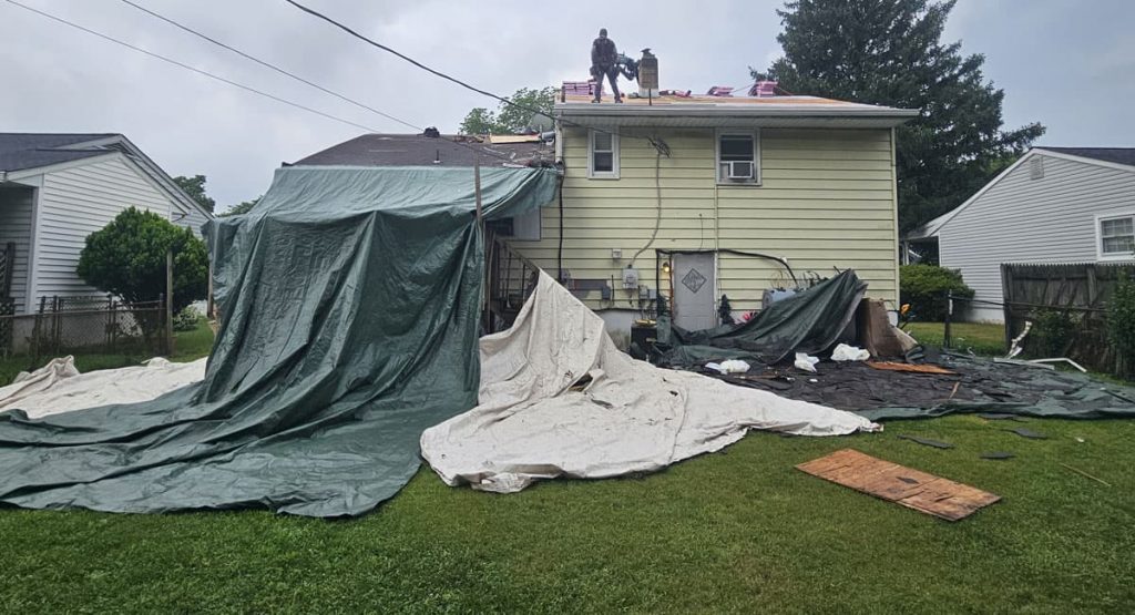 Tearing off old roof in New Castle, DE