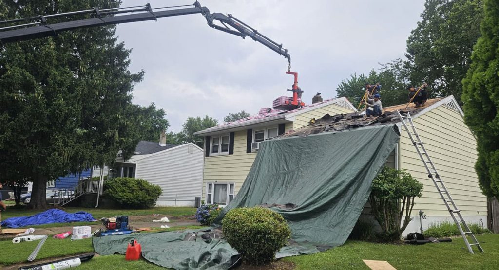 Tearing off old roof in New Castle, DE