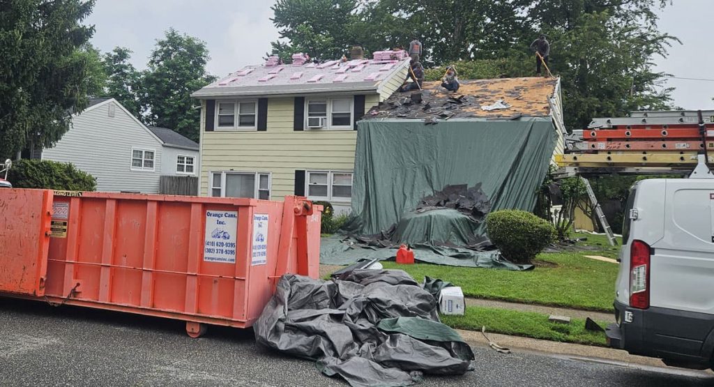 Tearing off old roof in New Castle, DE