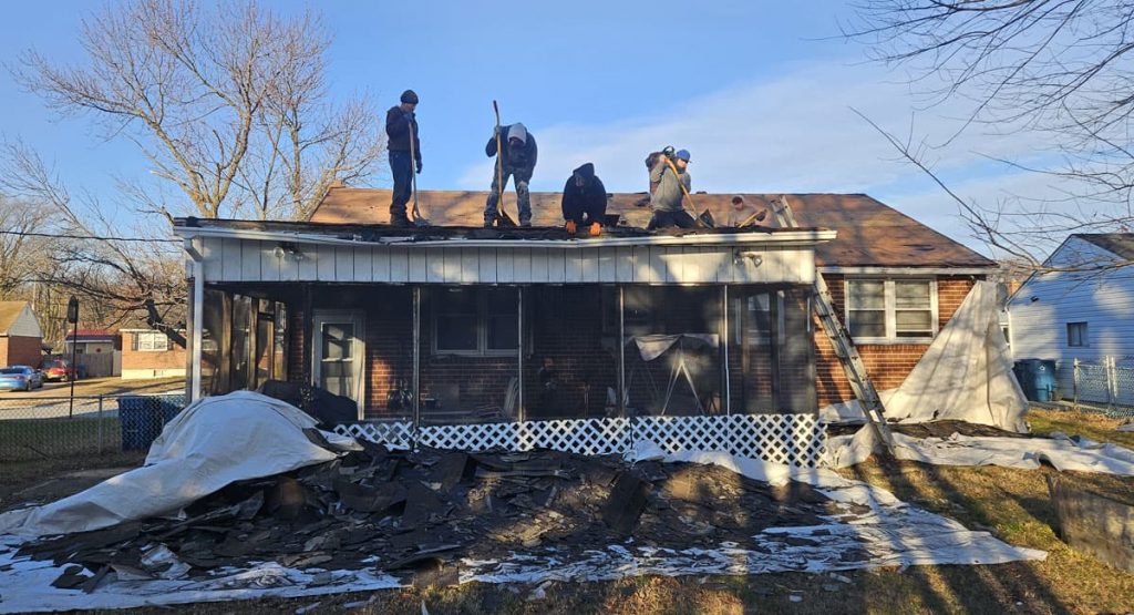 Tearing off old roof in New Castle, DE