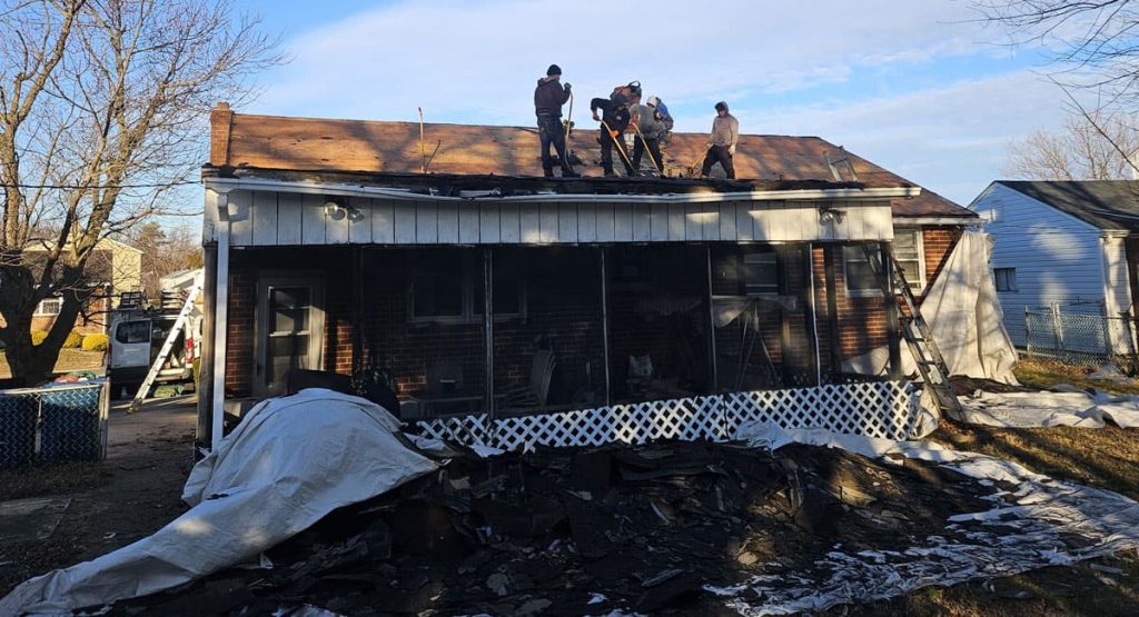 Tearing off old roof in New Castle, DE