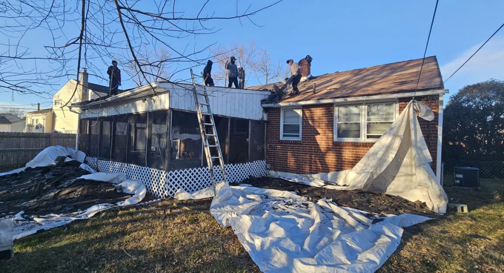 Tearing off old roof in New Castle, DE